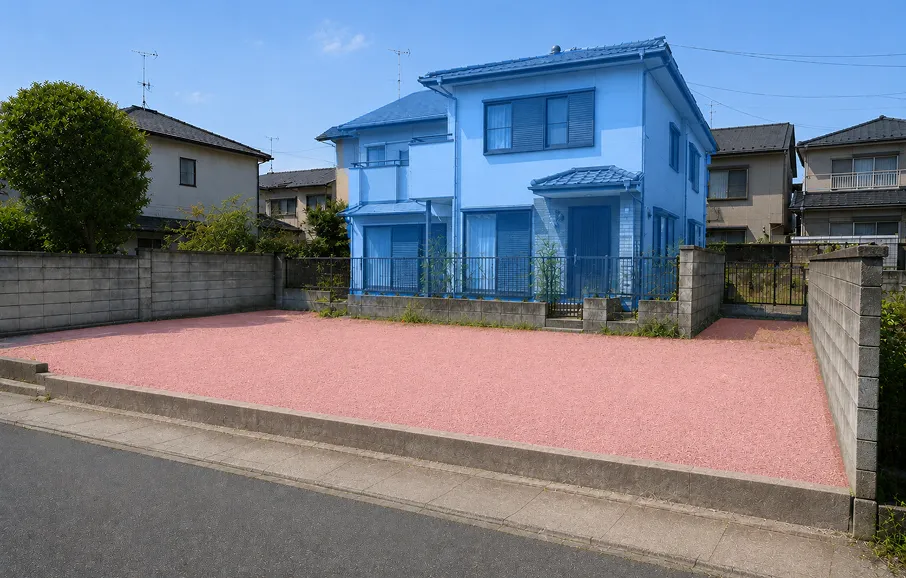 青くハイライトされた2階建て住宅と、ピンク色で示された借地部分の駐車スペース